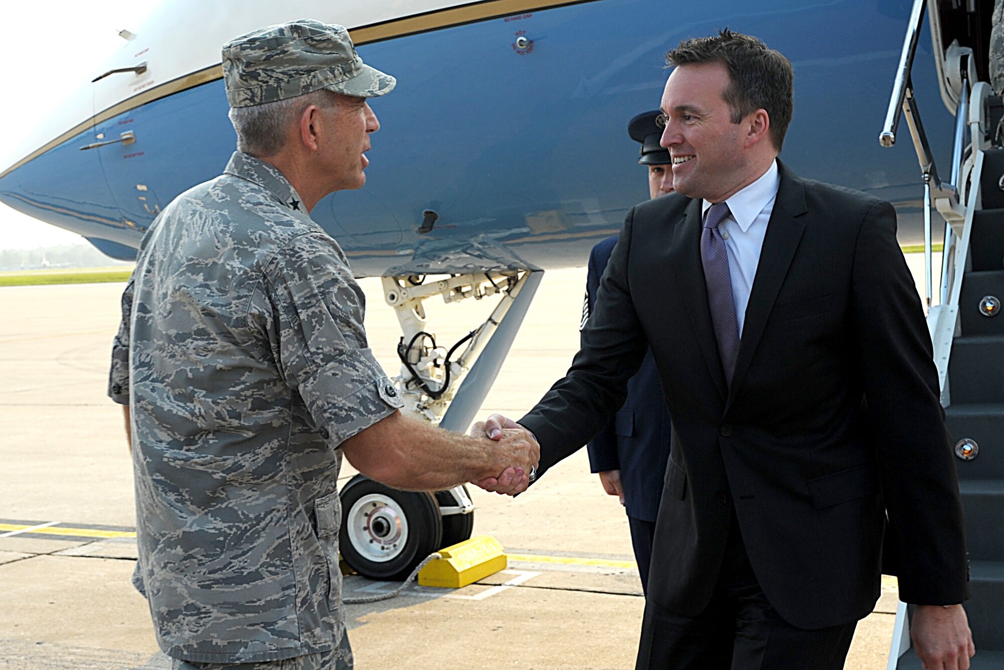 Acting Secretary of the Air Force Eric Fanning shakes hands with Lt. Gen. Brooks Bash, Air Mobility Command vice commander, during a visit to Scott Air Force Base, Ill., Aug. 22, 2013. During his visit, he spoke with Airmen about their concerns and explained future policies taking place in our nation's capital. 