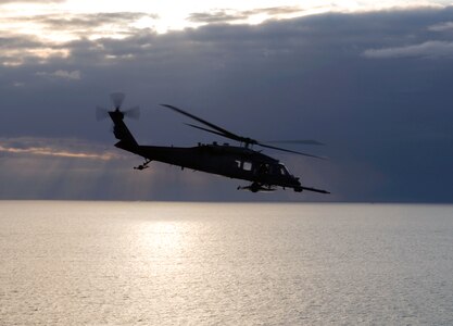 An Alaska Air National Guard HH-60 Pave Hawk combat search and rescue helicopter from the 210th Rescue Squadron flies over Cook Inlet April 30, 2013. A similar helicopter rescued the plane-crash survivors.