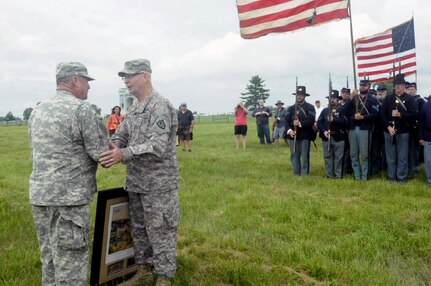 Minnesota National Guard Adjutant General Maj. Gen. Richard Nash and Alabama Adjutant General Maj. Gen. Perry Smith meet on the Plum Run ravine, the site of the deadliest battle in Gettysburg, to exchange gifts during the 150th anniversary of the battle.