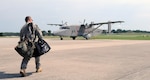 Sgt. 1st Class Troy Logsdon walks toward a C-23 Sherpa for a final pre-flight check at Capital City Airport in Frankfort, Ky., July 9, 2013.