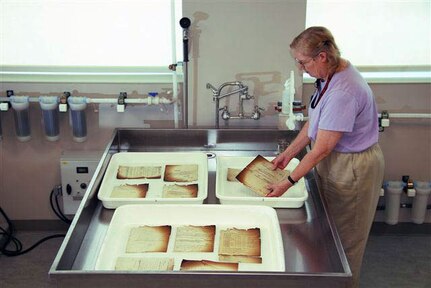 Preservation technician Susan Davis is part of a team working to restore military personnel records damaged during a July 12, 1973, fire at the National Personnel Records Center in suburban St. Louis.