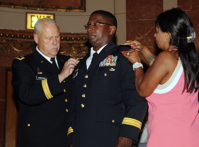 Brig. Gen. Wayne Black was promoted in a ceremony at the Indiana War memorial in Indianapolis, July 13, 2013. Assisting Maj. Gen. R. Martin Umbarger is Gen. Black's wife, Symea.