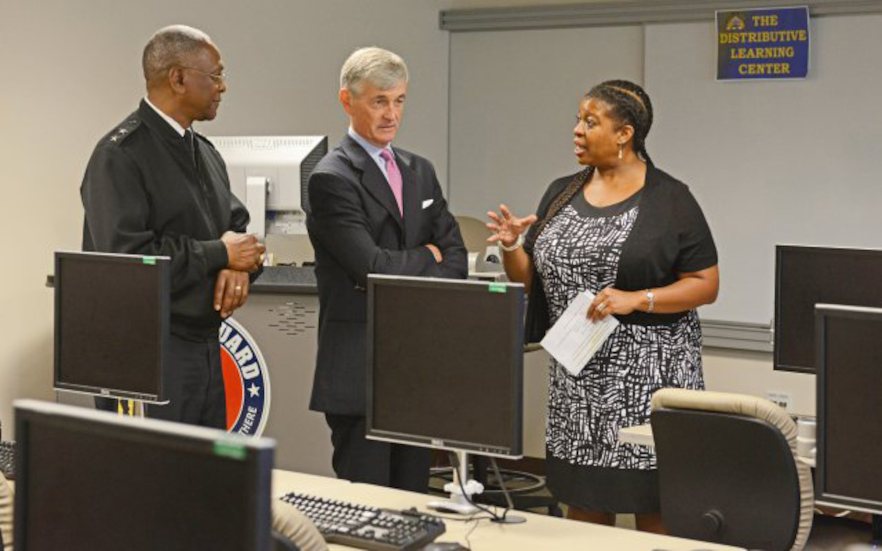 Secretary of the Army John McHugh, center, and District of Columbia National Guard Commander Maj. Gen. Errol R. Schwartz meet Terri Jones, Distance Learning manager for the D.C. National Guard, at the D.C. Armory, July 12, 2013.