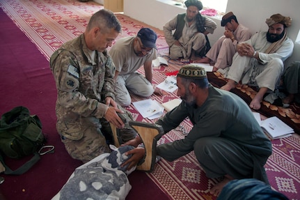 U.S. Army Maj. Eugene Johnson, a veterinarian with Georgia Agricultural Development Team 3, Regimental Combat Team 7, explains how to aid livestock with birthing problems during veterinary classes in Kajaki District, April 24, 2013.