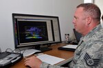 Air Force Staff Sgt. Brad Simon, Indiana Air National Guard, 181st Intelligence Wing, 113th Weather Flight forecaster on duty, analyzes weather conditions during annual training July 16, 2013, at the Combat Readiness Training Center, Alpena, Mich.