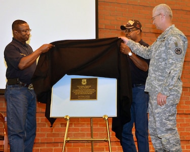 Trooper Willie Edly Jr., national president of the 9th and 10th Horse Cavalry Association, Trooper Milton Wiltz, president of the 9th and 10th Horse Cavalry Association Greater New Orleans Chapter 22, and Brig. Gen. Barry D. Keeling, director of the joint staff of the Louisiana National Guard, unveil a commemorative plaque during a ceremony to recognize the consolidation and formation of the 25th Infantry Regiment on July 24, 2013.