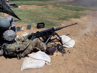 British Army Lt. Francesca Pinel fires a .50-caliber machine gun at Camp Gruber, Oklahoma while training with the Oklahoma Army National Guard.