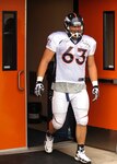 Benjamin Garland, Denver Broncos offensive guard, hits the sled during an offensive line drill at a Broncos training camp practice July 29, 2013, at the Broncos training facility, Englewood, Colo.