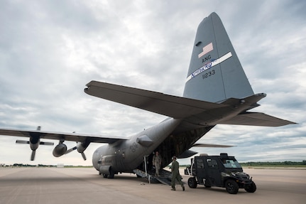 Members of the Kentucky Air National Guard’s 123rd Contingency Response Group unload an all-terrain vehicle at MidAmerica St. Louis Airport in Mascoutah, Ill., on Aug. 5, 2013, as part of Exercise Gateway Relief, a U.S. Transportation Command-directed earthquake-response scenario.