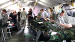 Airmen from the 139th Aeromedical Evacuation Squadron of the 109th Airlift Wing, while working with civilian agencies, provide treatment during an exercise to simulated patients, Civil Air Patrol cadets, after they were brought to the base from the Aplaus Fire Department, Aug. 8, 2013.