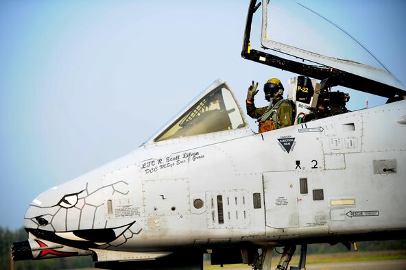 An A-10 Thunderbolt II aircraft pilot waves as he taxis down the runway during Red Flag-Alaska 13-3 Aug. 13, 2013, at Eielson Air Force Base, Alaska. Red Flag-Alaska is a series of Pacific Air Forces commander-directed field training exercises for U.S. and partner nation forces, providing combined offensive counter-air, interdiction, close-air support, and large force employment training in a simulated combat environment. The pilot is assigned to the 163rd Fighter Squadron, Indiana Air National Guard. (DOD photo/Staff Sgt. Jim Araos)