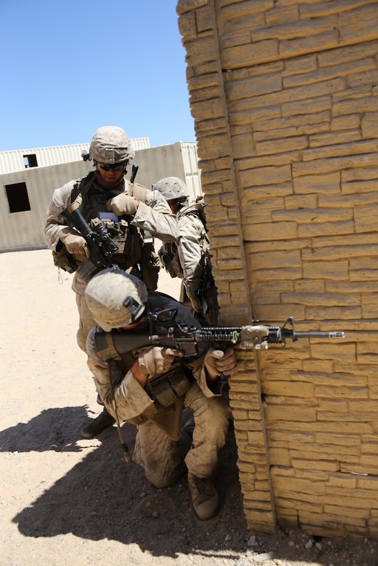 MARINE CORPS AIR GROUND COMBAT CENTER TWENTYNINE PALMS, Calif. – Marines serving with 3rd Battalion, 7th Marine Regiment, prepare to breach an enemy compound while conducting a mock raid during the Integrated Training Exercise here, Aug. 12, 2013. The Marines assume a supporting role while deployed to Afghanistan by letting the ANA and the Afghan National Police lead in combat operations. The ITX is a training exercise held to prepare Marines prior to their upcoming deployment to Afghanistan.