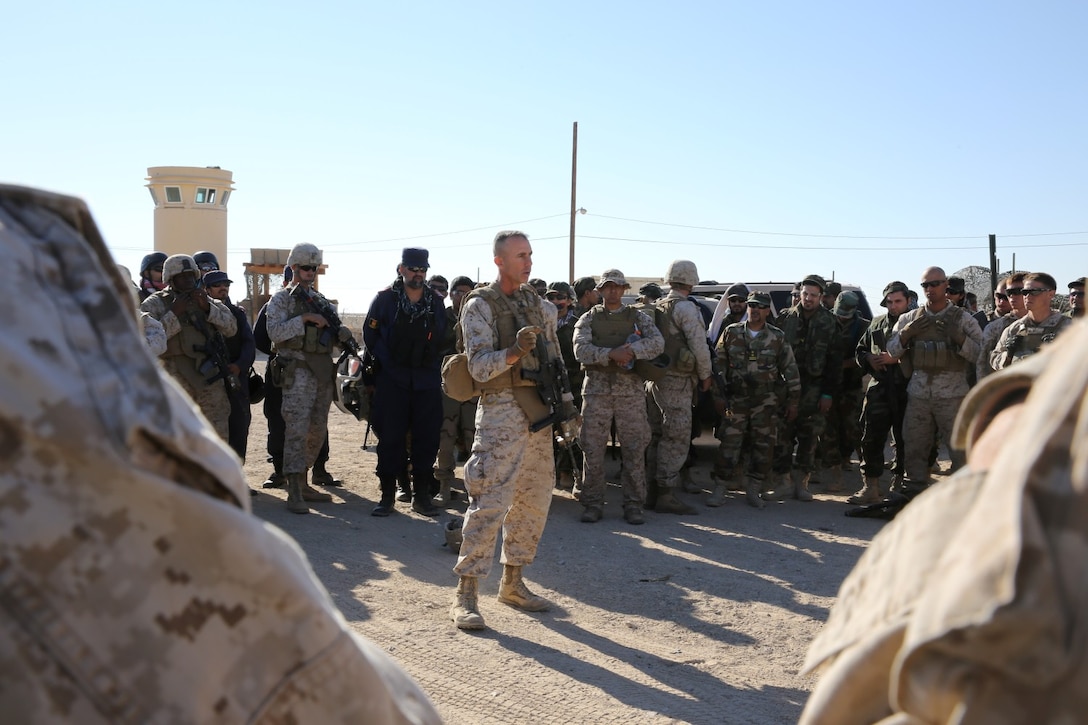 MARINE CORPS AIR GROUND COMBAT CENTER TWENTYNINE PALMS, Calif. – Lieutenant Col. Daniel Wittnam, the commanding officer of 3rd Battalion, 7th Marine Regiment, addresses the Marines of Kilo Company before a raid during the Integrated Training Exercise here, Aug. 12, 2013. Wittnam said he wanted the Marines and the role-players acting as the Afghan National Army and the Afghan National Police to work together while conducting the raid. The Marines assume a supporting role while deployed to Afghanistan by letting the ANA and the Afghan National Police lead in combat operations. The ITX is a training exercise held to prepare Marines prior to their upcoming deployment to Afghanistan.