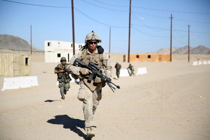 MARINE CORPS AIR GROUND COMBAT CENTER TWENTYNINE PALMS, Calif. – Lance Cpl. Dave Holm, rifleman, 3rd Battalion, 7th Marine Regiment, sprints to cover after receiving simulated enemy small-arms fire from an enemy role-player during the Integrated Training Exercise here, Aug. 12, 2013. Holm, 25, a native of Ottumwa, Iowa, and his team supported the main push into the mock town. The Marines will take a supporting role while deployed to Afghanistan by letting the Afghan National Army and the Afghan National Police lead in combat operations. The ITX is a training exercise held to prepare Marines prior to their deployment. The Marines assume a supporting role while deployed to Afghanistan by letting the ANA and the Afghan National Police lead in combat operations. The ITX is a training exercise held to prepare Marines prior to their upcoming deployment to Afghanistan.