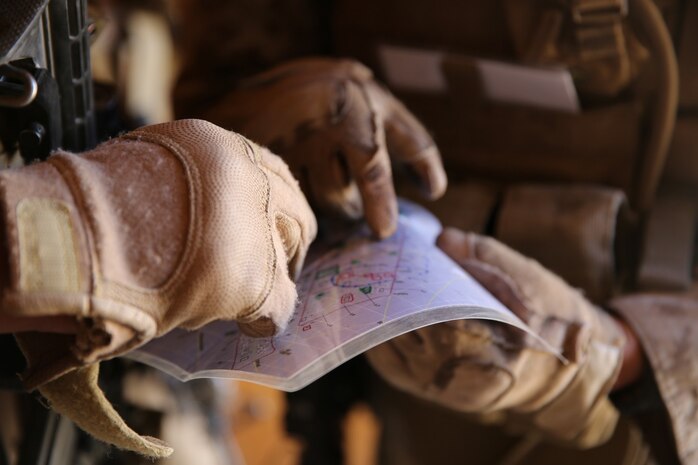MARINE CORPS AIR GROUND COMBAT CENTER TWENTYNINE PALMS, Calif. – Corporal Miles Potter, squad leader, 3rd Battalion, 7th Marine Regiment, points to key objectives on a map while conducting a mock raid during the Integrated Training Exercise here, Aug. 12, 2013. Potter, 25, a native of Riverside, Calif., and his team were in charge of securing the area to ensure the priority targets did not escape. The Marines assume a supporting role while deployed to Afghanistan by letting the ANA and the Afghan National Police lead in combat operations. The ITX is a training exercise held to prepare Marines prior to their upcoming deployment to Afghanistan.
