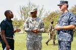 Missouri Army National Guard 1st Lt. Pesseglou Yoma, center, a native of Togo and fluent French speaker, translates a conversation between Lt. Col. Honnet Michel Sahiry of the Ivory Coast, and U.S. Navy Lt. John MacLean.