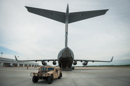 Members of the Kentucky Air National Guard’s 123rd Contingency Response Group offload a Humvee from a Mississippi Air National Guard C-17 at MidAmerica St. Louis Airport in Mascoutah, Ill., on Aug. 6, 2013, as part of Exercise Gateway Relief, a U.S. Transportation Command-directed earthquake-response scenario.