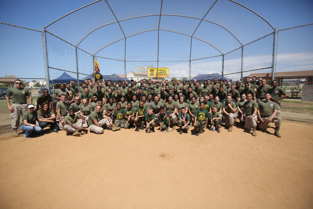 Marines and Young Marines pose together for a photo at Mills Park after the Big Marine Little Marine event aboard Marine Corps Air Station Miramar, Calif., Aug. 24. Both Young and active-duty Marines participated in the day-long event together. 