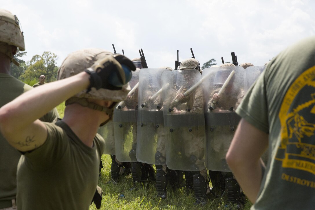 Marines with Battalion Landing Team 1st Battalion, 6th Marine Regiment, 22nd Marine Expeditionary Unit (MEU), train in riot control operations during a non-lethal weapons course at Marine Corps Base Camp Lejeune, N.C., Aug. 12, 2013.  The MEU is scheduled to deploy in early 2014 to the U.S. 5th and 6th Fleet areas of responsibility with the Bataan Amphibious Ready Group as a sea-based, expeditionary crisis response force capable of conducting amphibious missions across the full range of military operations. (U.S. Marine Corps photo by Sgt. Alisa J. Helin/Released)