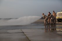 Marines with Bulk Fuel Company, 8th Engineer Support Battalion, 2nd Marine Logistics Group practiced moving with a fire hose during their annual training aboard Marine Corps Air Station Cherry Point, Aug. 28, 2013. Members of Aircraft Rescue Firefighting team assisted the bulk fuel Marines and made sure they learned everything they would need to know to effectively fight fires in the future. (U.S, Marine Corps photo by Lance Cpl. Shawn Valosin)