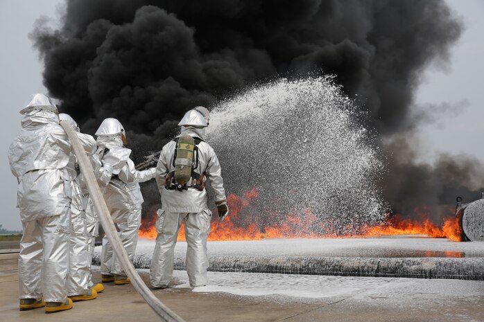 Marines with Bulk Fuel Company, 8th Engineer Support Battalion, 2nd Marine Logistics Group use Twin Agent Units to extinguish a blaze during a live fire training exercise aboard Marine Corps Air Station Cherry Point, Aug. 28, 2013. TAUs combine dry chemicals with water to create a foam that chokes the oxygen from a fire, stunting its growth and effectively ending it. (U.S. Marine Corps photo by Lance Cpl. Shawn Valosin)