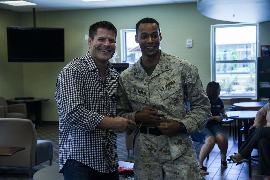 Former captain and professional Mixed Martial Arts fighter Brian Stann poses for a picture with Sgt. Marquis St. Thomas, an administrative specialist with Wounded Warrior Battalion aboard Marine Corps Base Camp Lejeune, Aug. 21.  Stann also met with Marines at the Central Area Recreation Center and the French Creek Barracks. 
