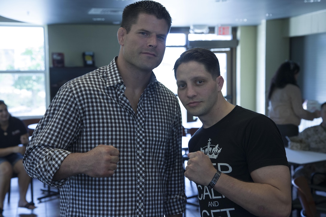 Former captain and professional Mixed Martial Arts fighter Brian Stann poses for a picture with Sgt. Caleb Patton at the Wounded Warrior Battalion aboard Marine Corps Base Camp Lejeune, Aug. 21. Stann said the Marine Corps gave him discipline, values and a code to live by that has helped him in all aspects of his life, so he tries to give back to the Marine Corps as much as possible.