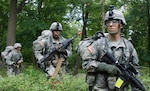 Spc. John Daras, right, Spc. Benjamin Lewis, center, and Spc. Joe Golonka, left, assault a simulated enemy position at the New York Army National Guard's annual Infantryman Transition Course Aug. 7, 2013.