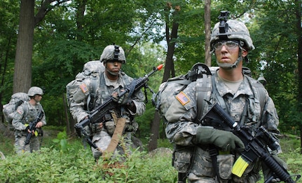 Spc. John Daras, right, Spc. Benjamin Lewis, center, and Spc. Joe Golonka, left, assault a simulated enemy position at the New York Army National Guard's annual Infantryman Transition Course Aug. 7, 2013.