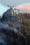 MAFFS 6, a C130J from the 146th Airlift Wing in Port Hueneme, Calif., drops a line of retardant over the trees in the mountains above Palm Springs July 19, 2013. The 146th Airlift Wing was activated July 18 to support CAL Fire and CAL OES on the Mountain fire and other potential wildfire activity throughout the state.