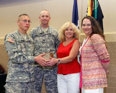 Pvt. Nathan Swaim, Capt. George Mosby, Darra Kennedy and Linda King with the box of World War II memorabilia found recently during a park cleanup.