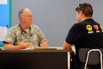 Army Col. Arnold "Skip" Jones, with Medical Command, 71st Troop Command, Texas Army National Guard, passes on medical advice to a patient during Operation Lone Star in Laredo, Texas. Operation Lone Star is a weeklong, real-time large scale emergency preparedness exercise that provides medical services and disaster recovery training to state agencies and personnel while addressing the medical needs of thousands of under-served Texas residents in the South Texas border region. 