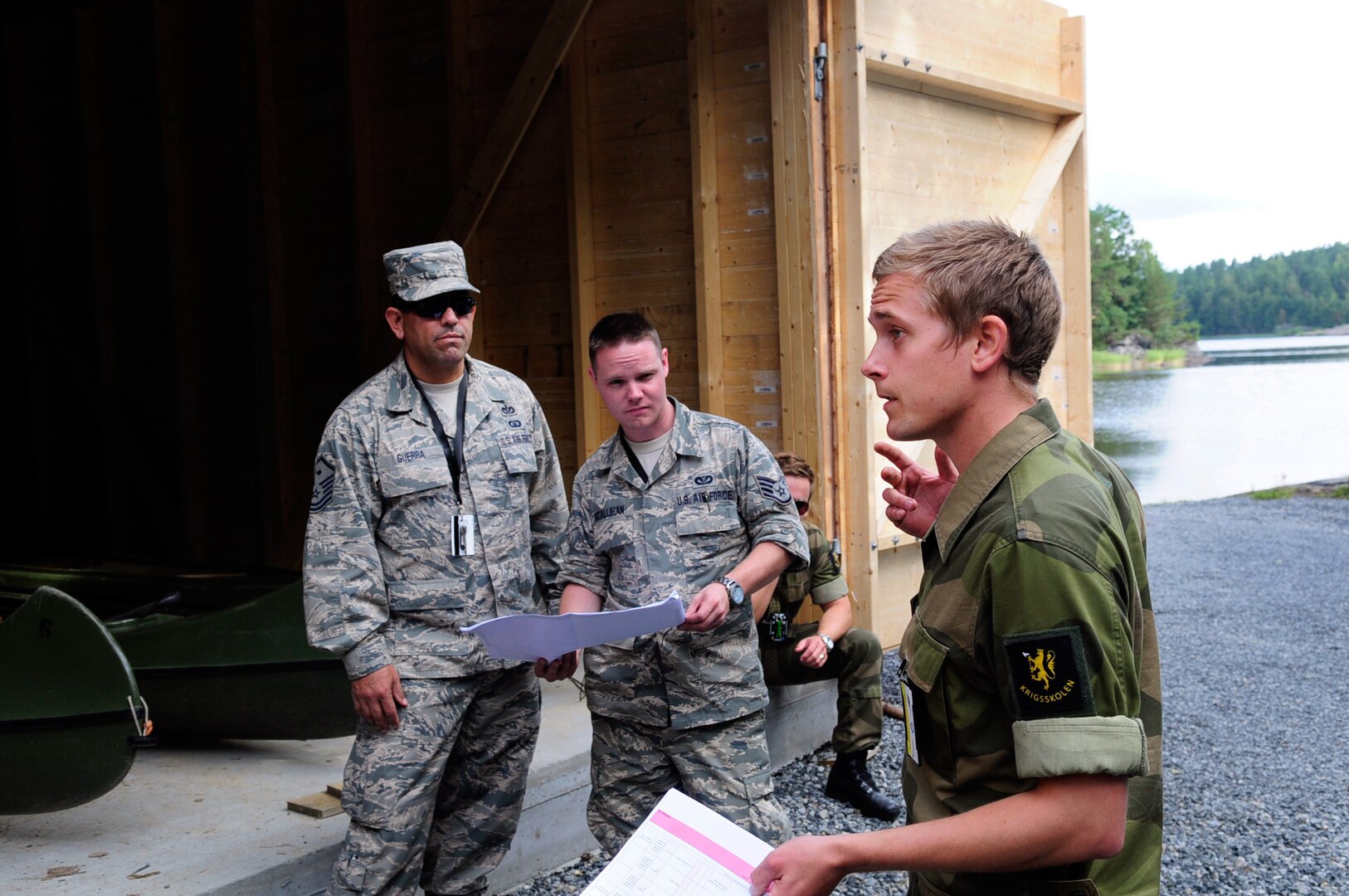 Norwegian Military Academy Cadet Kjetil Waal, a senior Royal Norwegian military cadet enrolled in the engineering program at the Norwegian Military Academy (Krigsskolen), at Camp Linderud, in Oslo, Norway, briefs members of the Texas Air National Guard's 149th Civil Engineering Squadron, on a construction project at Rygge Air Station, Norway. The 149th CES was in Norway as part of the deployment for training program to train with members of the Royal Norwegian armed forces.