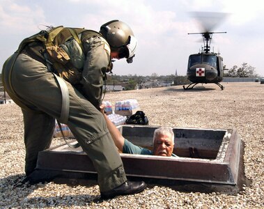 Army Maj. Timothy A. Doherty, with the Georgia Army National Guard's 148th Medical Company (Air Ambulance), helps a man from a school building near downtown New Orleans in the aftermath of Hurricane Katrina. More than 50,000 National Guard members responded to the disaster and by the end of September 2005 they had flown more 10,200 missions, airlifted more than 88,000 passengers to safety, moved roughly 18,000 tons of supplies and relief aid and saved more than 17,000 lives.