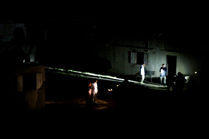 Marines serving with Alpha Company, 1st Reconnaissance Battalion, identify possible enemy combatant role-players during a mission rehearsal exercise here, Aug. 20, 2013. The Marines landed by helicopter at night and quickly raided several key compounds to catch the combatants off-guard. The MRX assessed the Marines' ability to execute their mission and coordinate logistics with their command element as they prepare to deploy with the 11th Marine Expeditionary Unit next year.