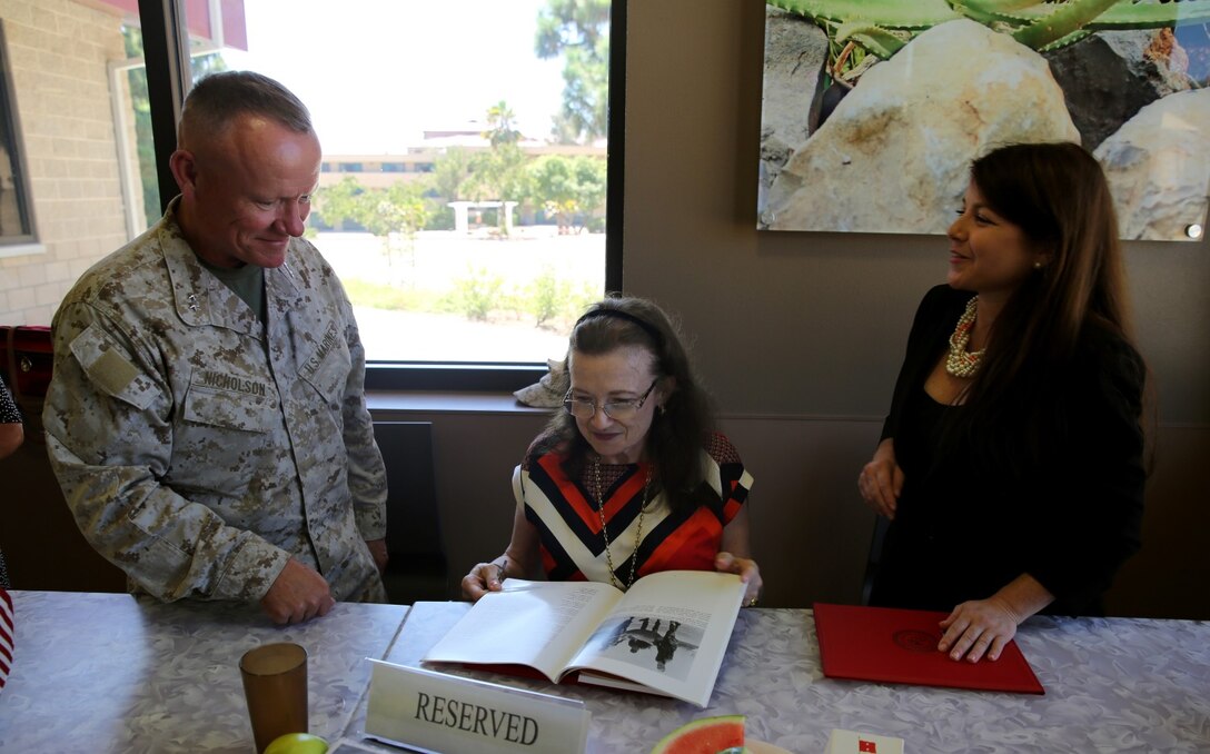 MARINE CORPS BASE CAMP PENDLETON, Calif. – Major Gen. Lawrence D. Nicholson, the commanding general of 1st Marine Division, presents a book on the history of Camp Pendleton to Gen. Alexander A. Vandegrift’s granddaughter and great granddaughter, Vallerey and Serina Vandegrift, during their visit here, Aug. 27, 2013. General Vandegrift was the 18th commandant of the Marine Corps and the first Marine officer on active duty to attain four-star rank.