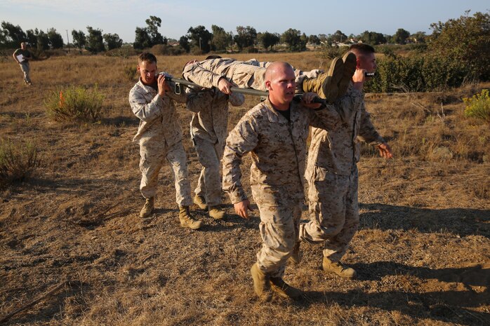 Sgt. Jason E. Aldrich, field instructor, Field Company, Weapons Field Training Battalion, carries a stretcher with other members of his squad to a landing zone during a squad competition at Edson Range aboard Marine Corps Base Camp Pendleton, Calif., Aug. 23. The Marines needed to reach the landing zone to medically evacuate the simulated casualty via aircraft.