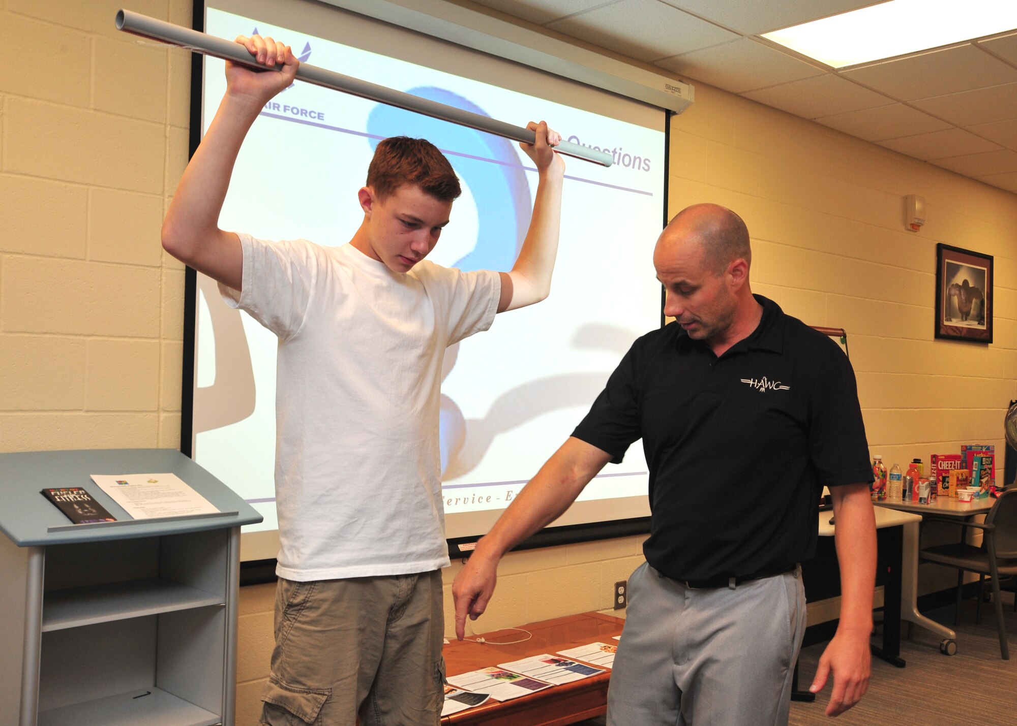Will Saultes, 92nd Aerospace Medicine Squadron Health and Wellness Clinic health promotion manager, speaks to kids at a Youth Clinic to discuss sports nutrition education, injury prevention and tips on how to improve performance at home and school at Fairchild Air Force Base, Wash., Aug. 27, 2013. The class was broken into two sections focusing on nutrition and sports performance.  (U.S. Air Force photo by Staff Sgt. Michael Means/Released)