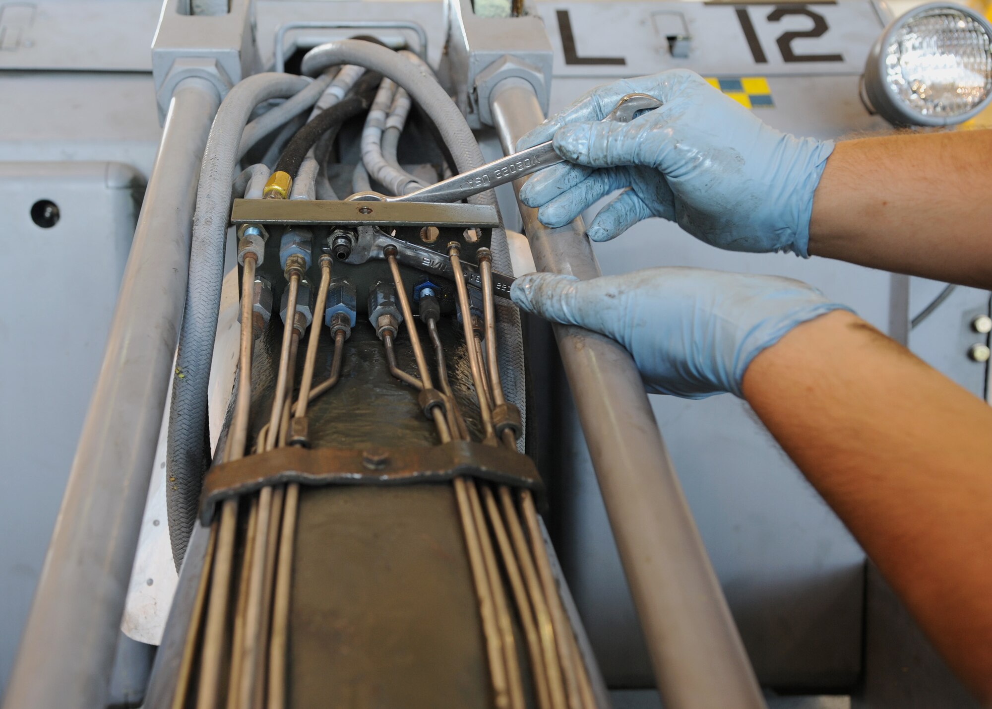 Senior Airman Nicholas Lindner, 307th Aerospace Ground Equipment journeyman, replaces unions on a MHU-83 bomb loader at Barksdale Air Force Base, La., Aug. 28, 2013. The unions are used to connect hydraulic lines and to assist in the flow of the hydraulic fluid from a smaller line to a larger line. (U.S. Air Force photo/Senior Airman Joseph A. Pagán Jr.)