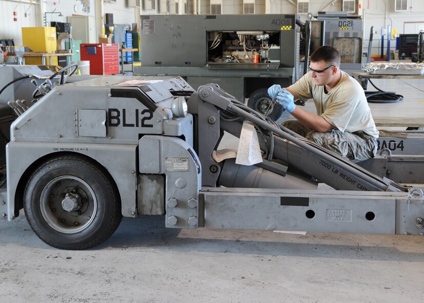 Senior Airman Nicholas Lindner, 307th Aerospace Ground Equipment journeyman, replaces unions on a MHU-83 bomb loader at Barksdale Air Force Base, La., Aug. 28, 2013. Unions are a type of fastener that connects hydraulic lines together. Lindner replaced the unions on the hydraulic lines because they were stripped and causing leakage. (U.S. Air Force photo/Senior Airman Joseph A. Pagán Jr.)