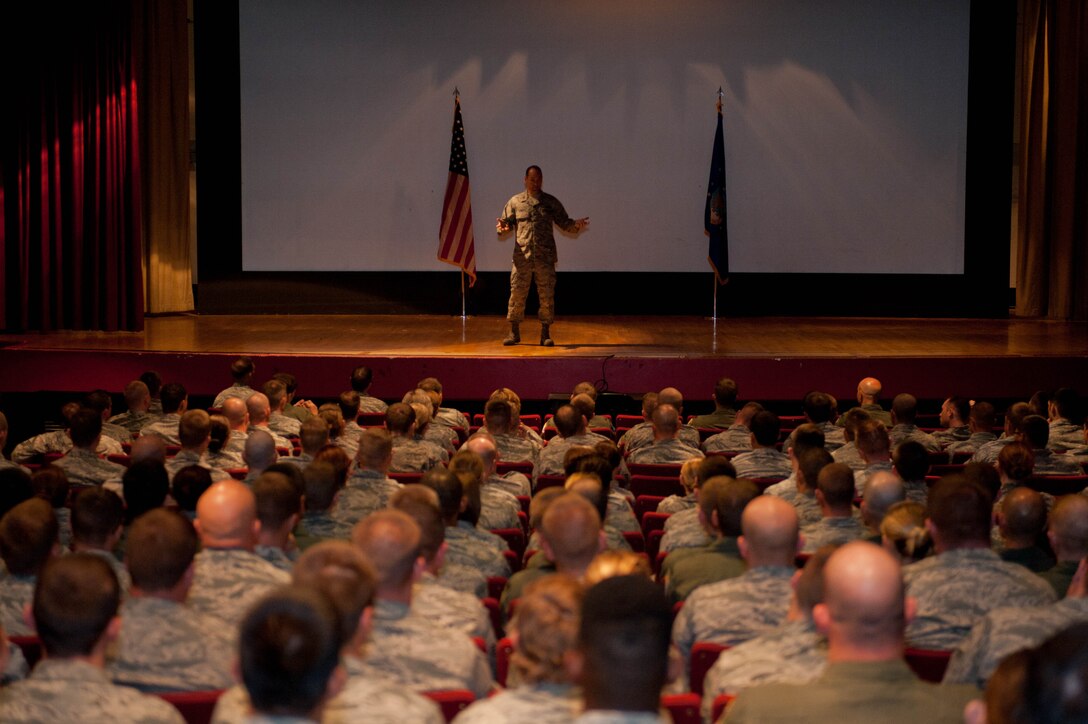 Ellsworth Airmen listen as Col. Kevin Kennedy, 28th Bomb Wing commander, explains his priorities during a commander's call in the base theater at Ellsworth Air Force Base, S.D., Aug. 29, 2013. Among the areas covered, safety was the main focus, with an emphasis on the importance of practicing operational risk management in the decision making process. (U.S. Air Force photo by Airman 1st Class Zachary Hada/Released)