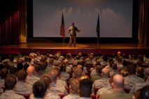 Ellsworth Airmen listen as Col. Kevin Kennedy, 28th Bomb Wing commander, explains his priorities during a commander's call in the base theater at Ellsworth Air Force Base, S.D., Aug. 29, 2013. Among the areas covered, safety was the main focus, with an emphasis on the importance of practicing operational risk management in the decision making process. (U.S. Air Force photo by Airman 1st Class Zachary Hada/Released)