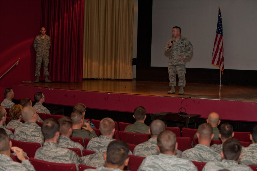Chief Master Sgt. Kevin Peterson, 28th Bomb Wing command chief, speaks to Airmen during a commander’s call in the base theater at Ellsworth AFB, S.D., Aug. 29, 2013. During the event wing leadership covered many topics, including safety, morale, and changes to the Air Force fitness program. (U.S. Air Force photo by Airman 1st Class Zachary Hada/Released)