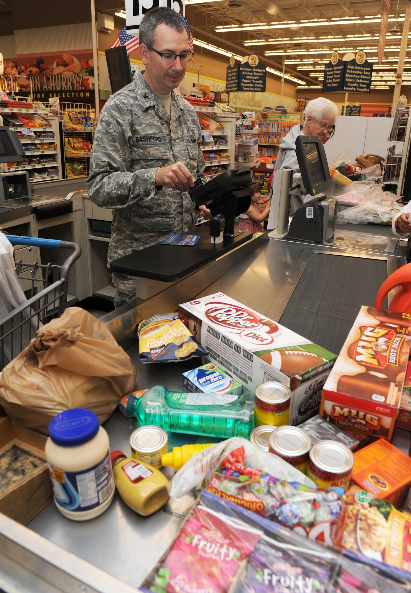 Col. Michael Bashford, 81st Surgical Operations Squadron, checks out at the commissary Aug. 29, 2013, Keesler Air Force Base, Miss.  The commissary restored its Monday hours after previously being closed on Mondays due to civilian furloughs.  (U.S. Air Force photo by Kemberly Groue)