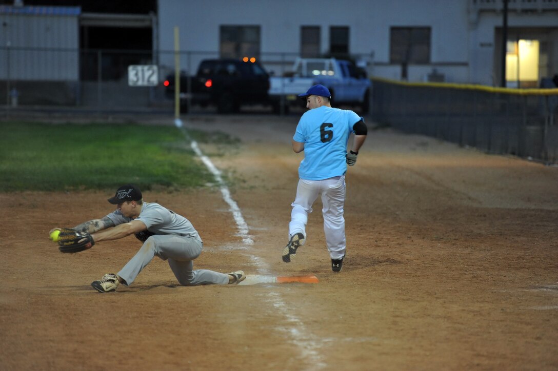 First baseman for the 898th Munitions Squadron intramural softball team stretches for a throw. The team won the championship game 16-12 over the 377th Weapons System Security Squadron. (Photo by Ken Moore)