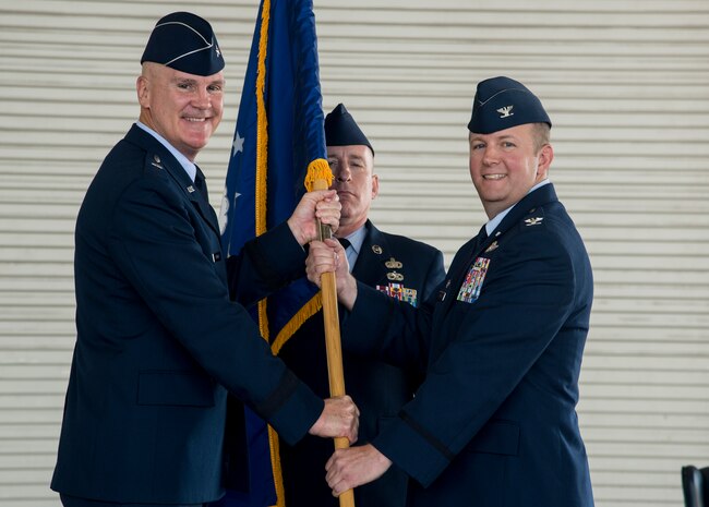 Brig. Gen. Randall Guthrie, U.S. Air Force Expeditionary Center commander, passes the guidon to Col. Jeffrey DeVore during the JB Charleston Change of Command ceremony, Aug. 29, 2013, at JB Charleston – Air Base. DeVore, previously the commander of the 386th Expeditionary Operations Group, Southwest Asia, officially assumed command from Col. Richard McComb  during the change of command ceremony. McComb will be assuming duties at the Pentagon, Washington D.C. As the JB Charleston commander, McComb provided installation support to a total force of more than 86,000 Airmen, Sailors, Soldiers, Marines, Coast Guardsmen, civilians, dependents and retirees across both the Air Base and Weapons Station. (U.S. Air Force photo/Tech. Sgt. Rasheen Douglas)