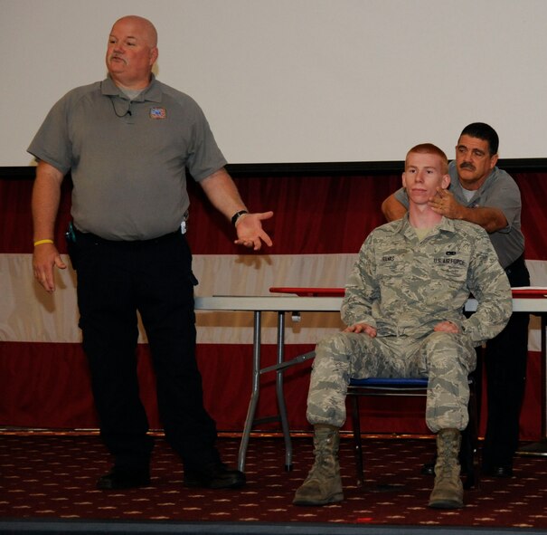 Airman 1st Class William Franks, front right, 2nd Maintenance Squadron crew chief, takes part in a demonstration with Greg McCarty, left,  and Ronny Garcia, Street Smart presenters, on Barksdale Air Force Base, La., Aug. 29, 2013. Street Smart is a program that seeks to educate people on taking safe measures when driving a vehicle, such as wearing seatbelts and avoiding driving while under the influence of alcohol or drugs. (U.S. Air Force photo/Airman 1st Class Andrew Moua)
