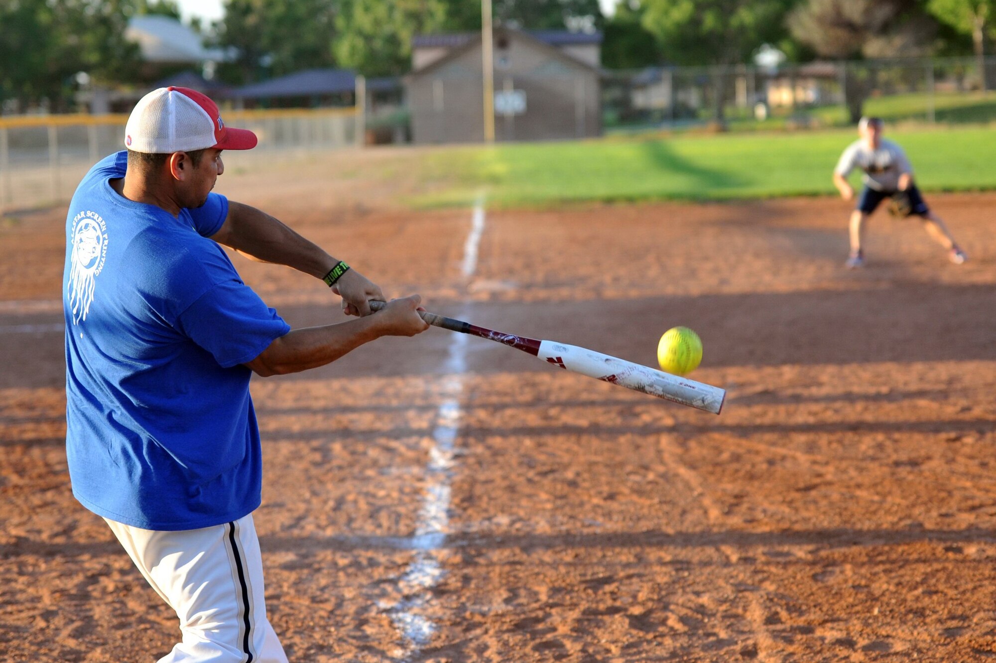 A player from the 377th Weapons System Security Squadron gets a base hit in the intramural softball championship game. It wasn't enough, as the team lost to the 898th Munitions Squadron 16-12. (Photo by Ken Moore)