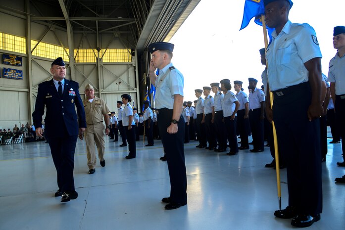 Col. Richard McComb, Joint Base Charleston commander, walks by the 628th Air Base Wing squadrons and their commanders performing an inspection during the JB Charleston Change of Command ceremony, Aug. 29, 2013, at JB Charleston – Air Base. DeVore,  previously the commander of the 386th Expeditionary Operations Group, Southwest Asia, officially assumed command from McComb during the change of command ceremony. McComb will be assuming duties at the Pentagon, Washington D.C. As the JB Charleston commander, McComb provided installation support to a total force of more than 86,000 Airmen, Sailors, Soldiers, Marines, Coast Guardsmen, civilians, dependents and retirees across both the Air Base and Weapons Station. (U.S. Air Force photo/Tech. Sgt. Rasheen Douglas)