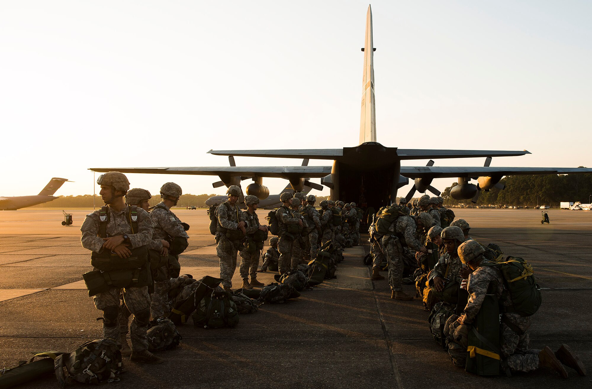 U.S. Army paratroopers from the 82nd Airborne Division perform an equipment check before boarding a C-130H Aug. 18, 2013, at Alexandria International Airport, La. The paratroopers were conducting a static line drop that marked the beginning of Joint Operational Access Exercise 13-0X. (U.S. Air Force photo by Staff Sgt. Russ Scalf)
